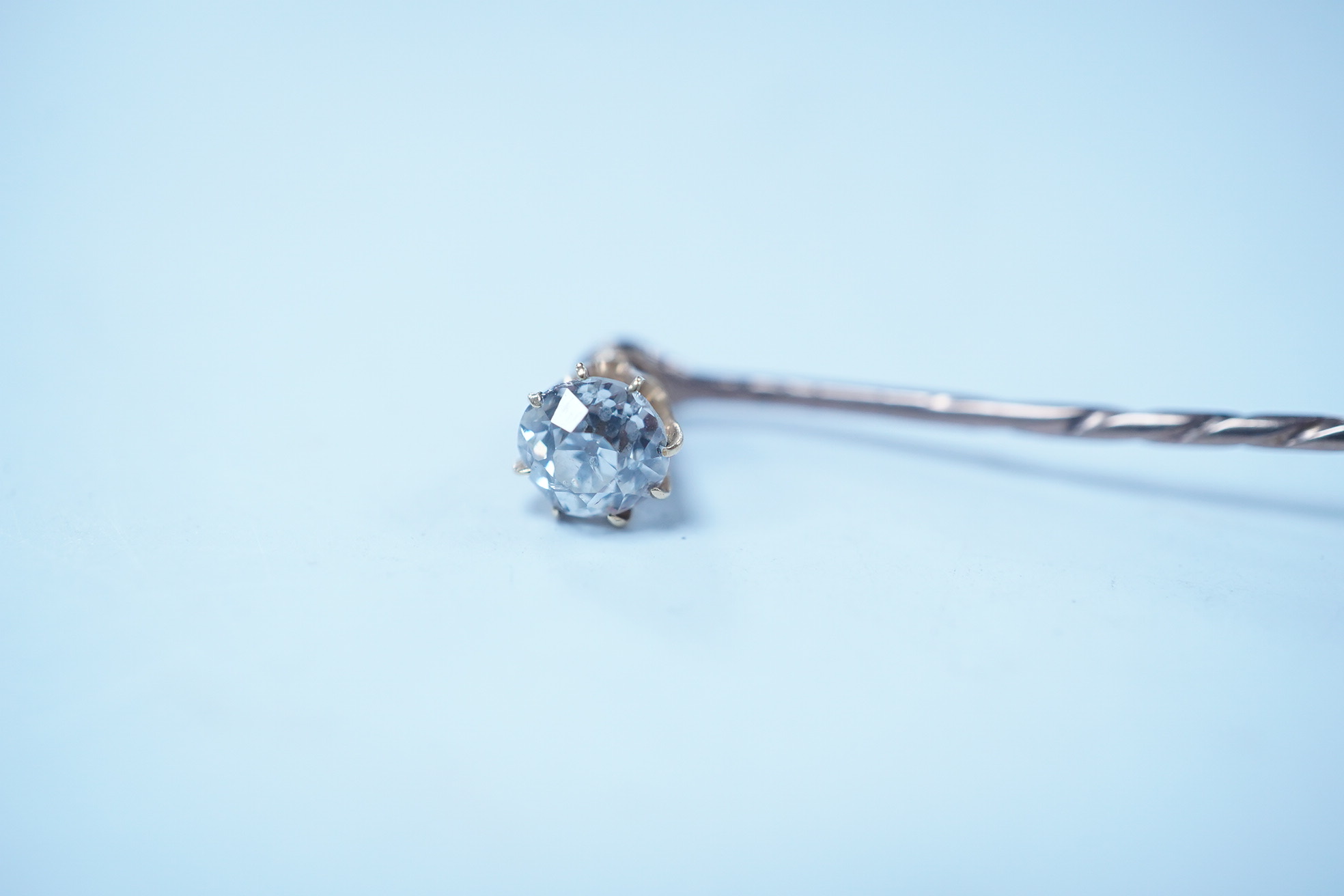 A yellow metal and solitaire diamond set stick pin, the stone diameter approx. 5mm, 59mm, gross weight 2.3 grams. Condition - fair to good